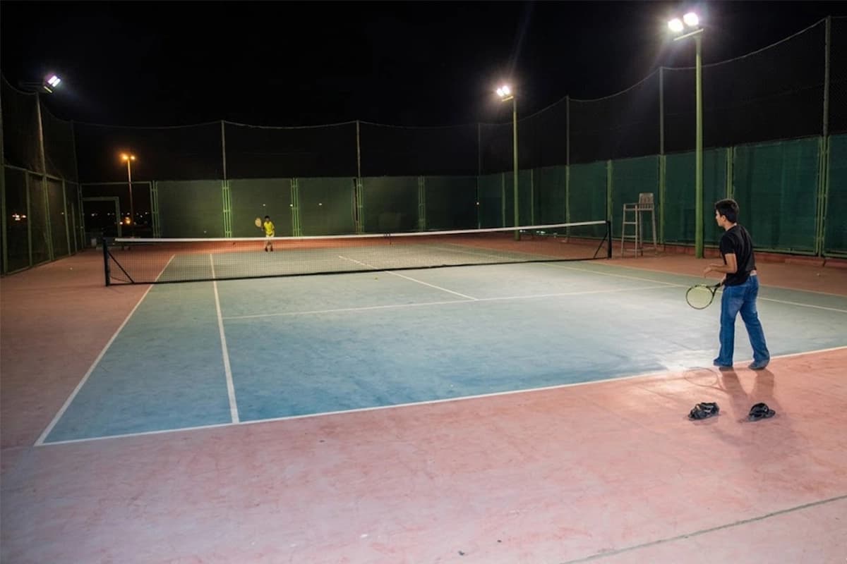 Tennis court floodlit match